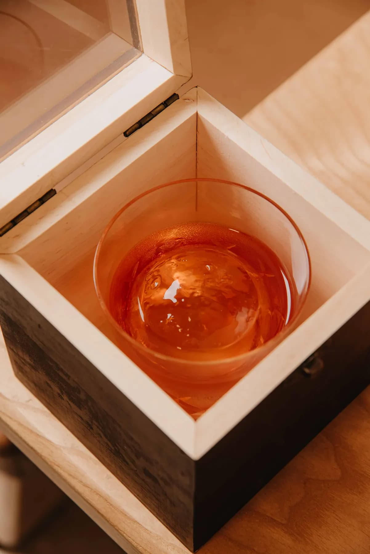 Ice sphere in a wooden box